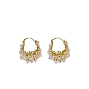Elegant gold-plated hoop earrings with clusters of white pearls in a French chic style