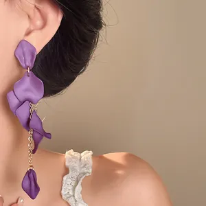 Close-up view of elegant Bohemian long purple petal tassel earrings worn by a model