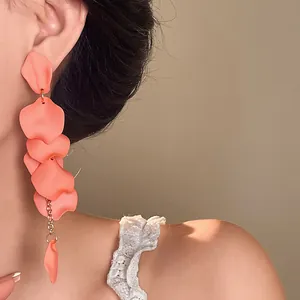 Detailed view of bohemian matte coral petal tassel earrings worn by a model