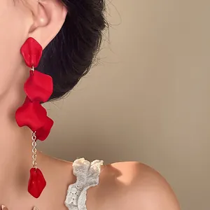 Elegant red petal tassel earrings worn by a model for a stylish bohemian look