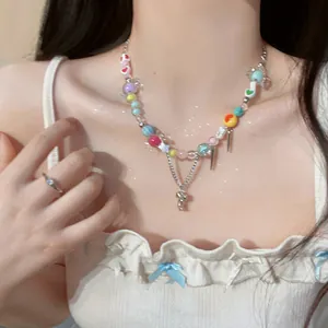 Close-up of vibrant dopamine style colorful beaded necklace with sweet charms on a model