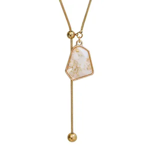 Elegant gold-plated adjustable Y-necklace featuring an irregular geometric marble stone pendant