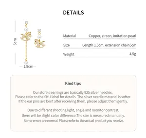 Detailed view of gold-plated rocking horse tassel earrings with pearls and zircons.