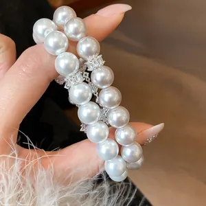 Detailed view of a double-strand pearl bracelet featuring elegant zircon flower accents