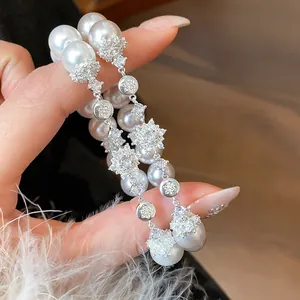 Detailed shot of French style zircon flower and pearl bracelet with elegant luster
