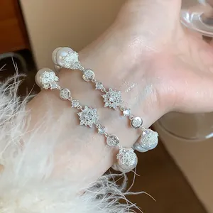 Close-up of elegant French style flower zircon and pearl bracelet luxury jewelry gift