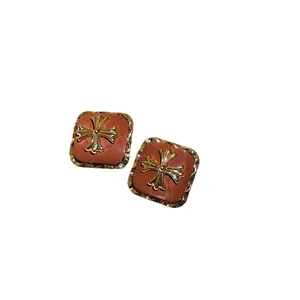 Vintage Maillard style brown square stud earrings with decorative golden floral cross