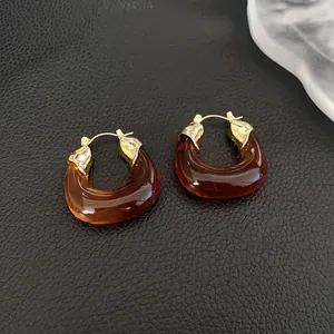 Detailed view of vintage Maillard brown resin hoop earrings with gold metal accents