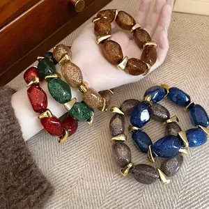 Set of colorful glitter acrylic oval beaded bracelets with gold metallic spacers
