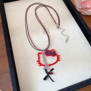 Close-up of a red Hello Kitty pendant necklace with ribbon detail in a jewelry tray