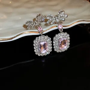 Elegant pink zircon bow earrings featuring a square crystal drop on a 925 silver needle