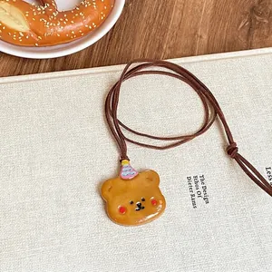 Charming brown bear pendant necklace with faux suede cord and colorful party hat