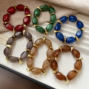 Multi-color acrylic oval beaded bracelets with gold spacers and glitter finish