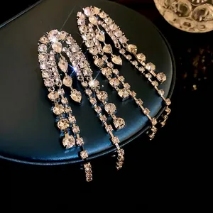 Elegant long tassel dangling earrings with silver needles and shimmering rhinestones