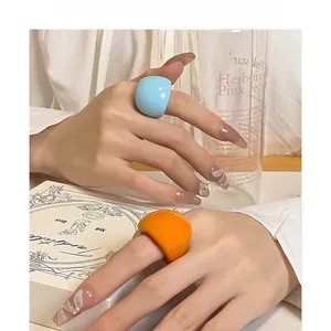 Trendy chunky resin statement rings in vibrant blue and orange glossy finish for women