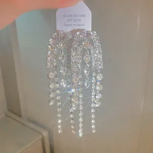 Close-up of silver-plated long tassel earrings with shimmering rhinestones for women.