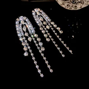 Elegant macro view of sparkling silver-tone long fringe tassel earrings with rhinestones