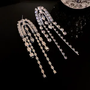 Detailed view of silver-toned long tassel earrings adorned with sparkling rhinestones.