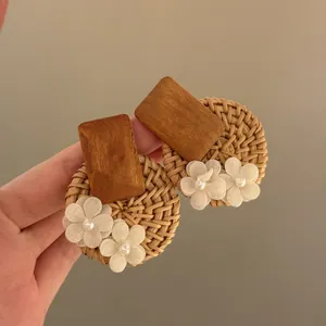 Bohemian style rattan and wood stud earrings with delicate white fabric flowers and pearls