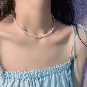 Detailed view of sweet pastel woven seed bead choker necklace worn for a summer look