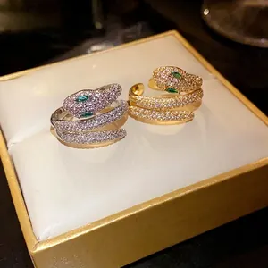 Elegant gold and silver snake open rings with sparkling zirconia and green eyes