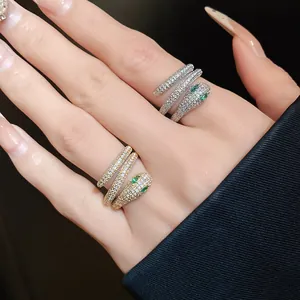 Detail view of sparkling snake-shaped open rings in gold and silver finishes