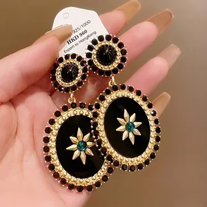 Vintage palace style oval drop earrings with black stones and gold star motif