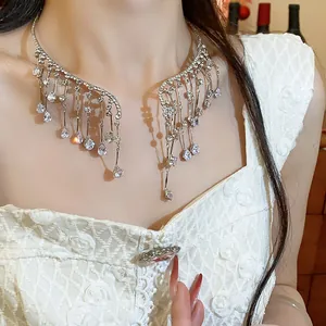 Close-up of an elegant silver rhinestone teardrop fringe necklace worn by a model