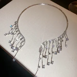 Detailed close-up of a luxury silver-toned choker with sparkling rhinestone tassels.