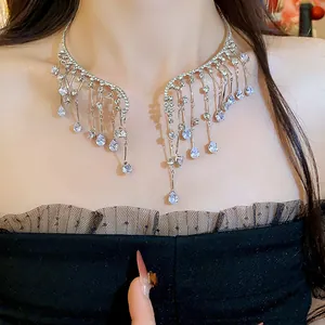 Close-up detail of a silver rhinestone wing-shaped choker necklace with drop crystals