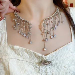 Detailed close-up showing the sparkling rhinestone water drop fringe necklace on model
