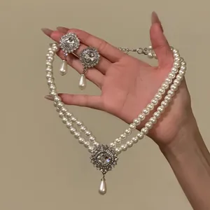 Close-up of vintage French style double-strand pearl necklace and matching drop earrings