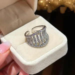 Close-up of minimalist silver hollow zircon open ring in a luxury beige jewelry box