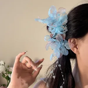 Detailed view of elegant blue mesh flower hair clip with pearl tassels for women