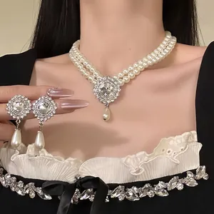 Detailed close-up of a French vintage pearl and rhinestone necklace earring set