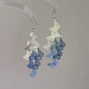 Detailed view of elegant hollow-out butterfly earrings featuring blue and white spray-painted gradient