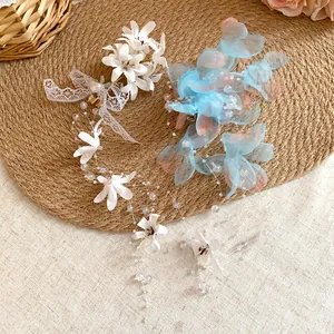 Detailed view of forest-style mesh flower hair clips with elegant tassels and beads.