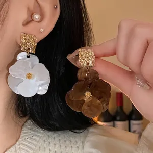 Statement large floral geometric earrings with an elegant white and brown finish