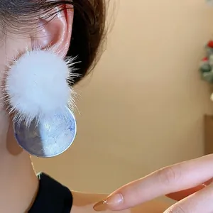 Stylish white pom-pom and blue marbled resin circular stud earrings for women.