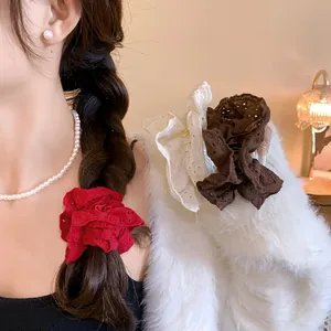Detailed view of elegant French style hollow lace flower scrunchies in red white and brown