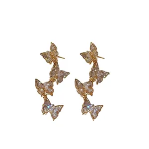 Elegant gold-tone zircon butterfly drop earrings set on a clean white background