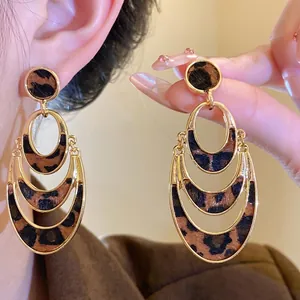 Elegant leopard print hollow oval earrings featuring a sophisticated gold-toned layered design.