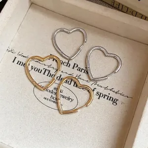 Elegant heart-shaped hoop earrings in gold and silver finish, minimalist jewelry