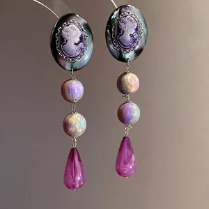 Vintage cameo resin drop earrings with iridescent beads and purple teardrop pendants