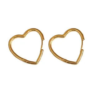 Elegant gold polished heart-shaped huggie earrings for a minimalist and stylish look.