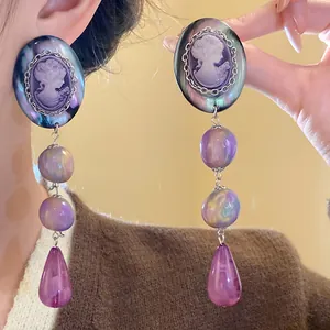 Vintage cameo portrait dangle earrings with iridescent purple beads and teardrop tassels