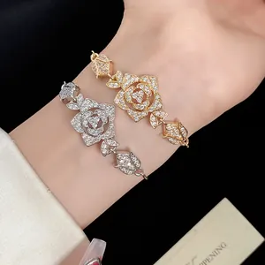 Detail showing gold and silver rose bracelets with sparkling cubic zirconia on wrist.