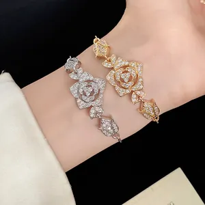 Close-up detail of silver and gold vintage flower bracelets with sparkling zircons