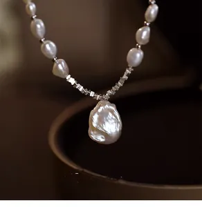 Detail shot of irregular Baroque pearl necklace with lustrous water-drop pendant