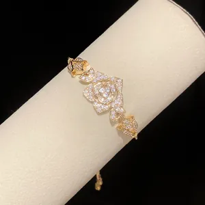 Close-up view of a vintage gold-toned rose flower bracelet with sparkling cubic zirconia